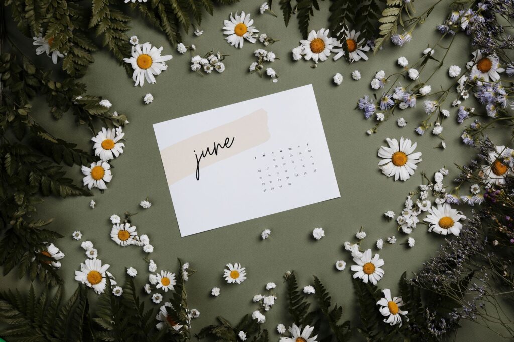 ferns and flowers surrounding a calendar